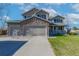 Charming two-story home featuring a stone facade and a spacious three-car garage at 957 Rosedale St, Castle Rock, CO 80104
