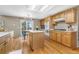 Well-lit kitchen featuring light wood cabinetry, hardwood floors, and a center island at 957 Rosedale St, Castle Rock, CO 80104