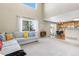 Open living area with large window, a gray sofa, and backyard access at 957 Rosedale St, Castle Rock, CO 80104