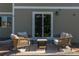 Cozy outdoor patio with wicker seating, ideal for relaxing and entertaining at 957 Rosedale St, Castle Rock, CO 80104
