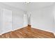 Spacious bedroom with hardwood flooring, neutral walls, and open closet for versatile living at 2100 N Franklin St # 15, Denver, CO 80205