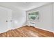 This cozy bedroom features hardwood floors and a window with green trimming and brings in plenty of natural light at 2100 N Franklin St # 15, Denver, CO 80205