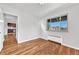 Sunlit bedroom featuring hardwood flooring, open layout leading to an updated kitchen, and bright window at 2100 N Franklin St # 15, Denver, CO 80205