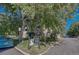 Brick building with green awning surrounded by mature trees on a sunny day at 2100 N Franklin St # 15, Denver, CO 80205