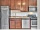 Kitchen featuring stainless steel appliances, dark wood cabinetry, and granite countertops at 2100 N Franklin St # 15, Denver, CO 80205