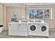 Clean laundry room with washers and dryers, and a bright window at 2100 N Franklin St # 15, Denver, CO 80205
