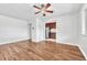 Inviting living room with shining hardwood floors, neutral walls and modern ceiling fan; adjacent to stainless kitchen at 2100 N Franklin St # 15, Denver, CO 80205