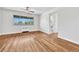 Bright living room featuring hardwood floors, a large window, and ceiling fan for a comfortable and inviting atmosphere at 2100 N Franklin St # 15, Denver, CO 80205