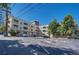 Exterior view of the building with parking lot, manicured trees, and awnings at 2100 N Franklin St # 15, Denver, CO 80205