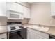 Clean kitchen, featuring white cabinets and stove top at 5300 E Cherry Creek South Dr # 905, Denver, CO 80246