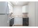 Compact kitchen with white cabinets and appliances at 5300 E Cherry Creek South Dr # 905, Denver, CO 80246