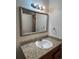 Clean bathroom with granite countertop, single sink, and updated vanity at 14697 E Oregon Dr, Aurora, CO 80012