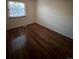 Simple bedroom with wood-look floors and a window at 14697 E Oregon Dr, Aurora, CO 80012