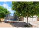Backyard featuring a trampoline, large trees, and a well-maintained lawn, ideal for outdoor activities at 16673 E Kent Dr, Aurora, CO 80013