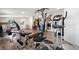 Well-lit basement gym with laminate floors and a variety of workout equipment for a complete fitness experience at 16673 E Kent Dr, Aurora, CO 80013
