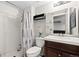 Bathroom with stall shower, single sink vanity and framed mirror at 16673 E Kent Dr, Aurora, CO 80013