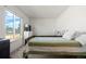 Bright, carpeted bedroom featuring two twin beds, a window, and white walls at 16673 E Kent Dr, Aurora, CO 80013