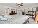 Spacious bedroom featuring a full length mirror, a ceiling fan, and a comfortable bed at 16673 E Kent Dr, Aurora, CO 80013