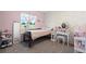 Charming pink bedroom with floral wallpaper, a full bed, vanity and carpeted floors at 16673 E Kent Dr, Aurora, CO 80013