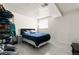 Minimalist bedroom with light gray tile floor, window, and a black platform bed at 16673 E Kent Dr, Aurora, CO 80013
