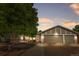 Charming single-Gathering home boasts a three-car garage and a well-maintained front yard at dusk at 16673 E Kent Dr, Aurora, CO 80013