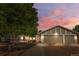 Charming single-Gathering home boasts a three-car garage and a well-maintained front yard at dusk at 16673 E Kent Dr, Aurora, CO 80013