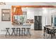 Bright kitchen featuring a breakfast bar with seating, stainless steel appliances, and a neutral color palette at 16673 E Kent Dr, Aurora, CO 80013