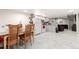 Open basement kitchen and dining area with tile floors, gray cabinets, and white appliances at 16673 E Kent Dr, Aurora, CO 80013