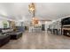 Spacious living room featuring tile floors, a fireplace, beamed ceilings, and an open floor plan at 16673 E Kent Dr, Aurora, CO 80013