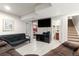 Basement area featuring tiled floors, a large screen TV, and comfortable seating at 16673 E Kent Dr, Aurora, CO 80013