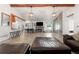 Spacious living room featuring tile floors, a fireplace, beamed ceilings, and an open floor plan at 16673 E Kent Dr, Aurora, CO 80013