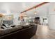 Spacious living room featuring tile floors, a fireplace, beamed ceilings, and an open floor plan at 16673 E Kent Dr, Aurora, CO 80013