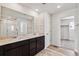 Bathroom with double sink vanity, large mirror, and a separate shower enclosure at 5918 Red Barn Ave, Mead, CO 80504