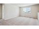 Spacious bedroom with neutral carpet, natural light and a large window overlooking the neighborhood at 5918 Red Barn Ave, Mead, CO 80504