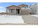 Inviting two-story home showcasing a manicured lawn, covered entrance, and an attached two-car garage at 5918 Red Barn Ave, Mead, CO 80504