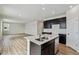 Bright, modern kitchen with stainless steel appliances and a central island, seamlessly flowing into the living area at 5918 Red Barn Ave, Mead, CO 80504