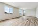 Spacious living room featuring hardwood floors and multiple windows at 5918 Red Barn Ave, Mead, CO 80504