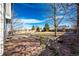 Spacious backyard with flagstone patio, firepit, and mature trees at 168 Peabody St, Castle Rock, CO 80104