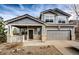 Two-story house with gray siding, brick accents, and a two-car garage at 168 Peabody St, Castle Rock, CO 80104