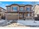 Two-story house with brown siding, stone accents, and a two-car garage at 12606 Fisher St, Englewood, CO 80112