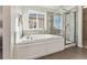 Main bathroom with soaking tub and walk-in shower at 12606 Fisher St, Englewood, CO 80112