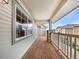 Covered back porch offering a relaxing outdoor space with sturdy railings and scenic neighborhood views at 10818 Cimarron St # 307, Firestone, CO 80504