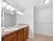 Bathroom with double sink vanity, tile floor, and bright lighting at 10818 Cimarron St # 307, Firestone, CO 80504
