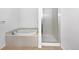 Bathroom featuring a large soaking tub and separate glass enclosed shower at 10818 Cimarron St # 307, Firestone, CO 80504