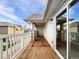 Spacious wooden deck with stone accents and sliding glass door at 10818 Cimarron St # 307, Firestone, CO 80504