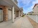 Inviting townhome exterior with stone accents, covered entryway, and well-maintained landscaping at 10818 Cimarron St # 307, Firestone, CO 80504
