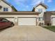 Exterior view of a well-maintained home with an attached garage and a spacious driveway at 10818 Cimarron St # 307, Firestone, CO 80504