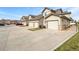 Row of townhomes featuring attached garages, ample parking, and well-kept grounds at 10818 Cimarron St # 307, Firestone, CO 80504