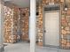 Close-up of a well-maintained front door, highlighted by stone accents and a secure entryway at 10818 Cimarron St # 307, Firestone, CO 80504