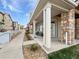 Inviting front porch with stone accents, covered seating, and meticulously landscaped surroundings at 10818 Cimarron St # 307, Firestone, CO 80504